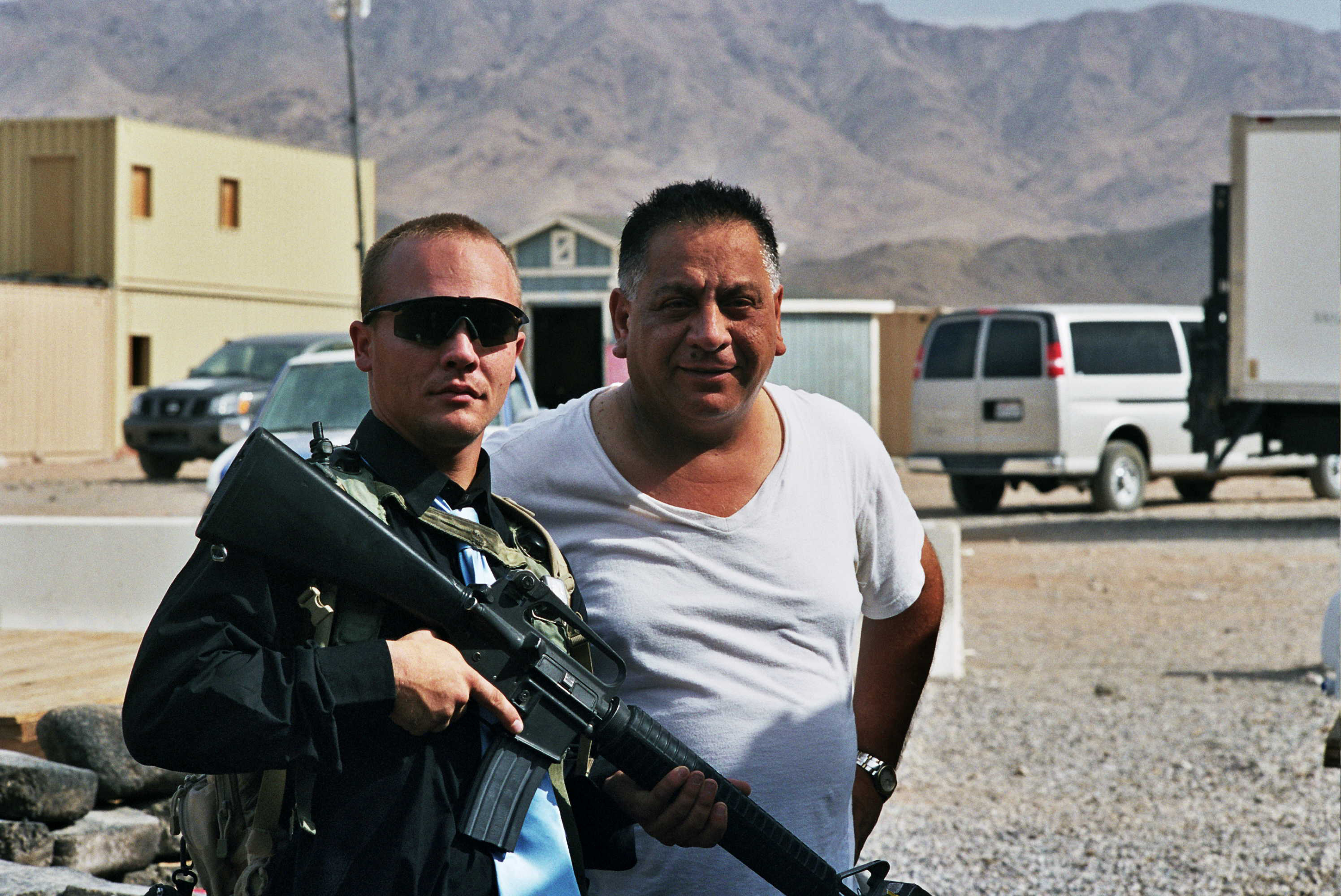 Bassam Kalasho (right), an Iraqi role player, is
the "deputy mayor" of Medina Wasl, posing with a U.S. soldier playing an "insurgent� (Photo: Tony Gerber)
