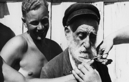 Unindentified men cutting the beard off 
an Eastern European Jew
Photo: First Run Features